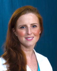 Ann Igoe, MD, wearing a white coat